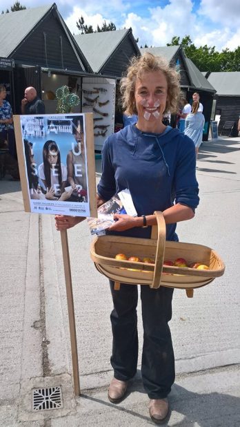 a-volunteer-dressed-as-a-fruit-picker-holding-a-basket-and-placard